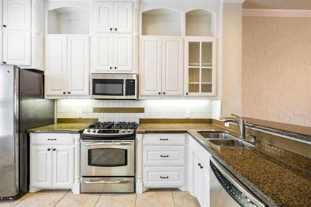 554 Rockingham Drive Irving, TX 75063 - Photo 15 of 34 a kitchen with granite countertop a stove sink and microwave