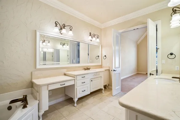 a spacious bathroom with a granite countertop sink mirror and bathtub