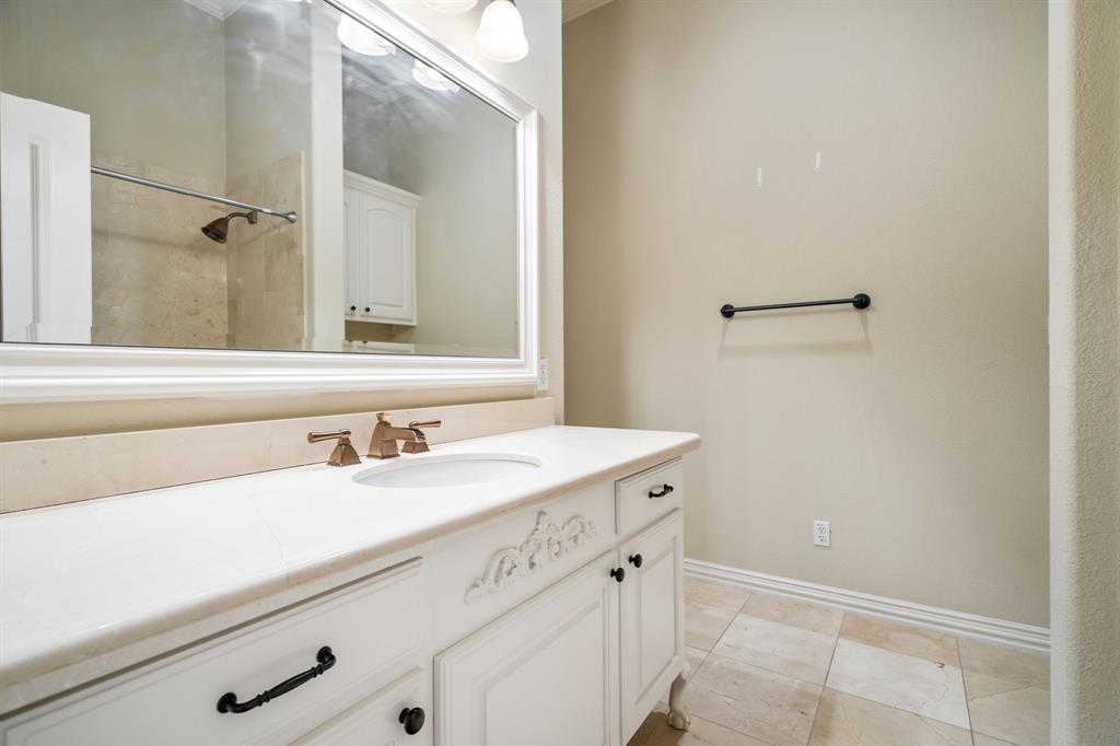 554 Rockingham Drive Irving, TX 75063 - Photo 29 of 34 a bathroom with a sink and a mirror