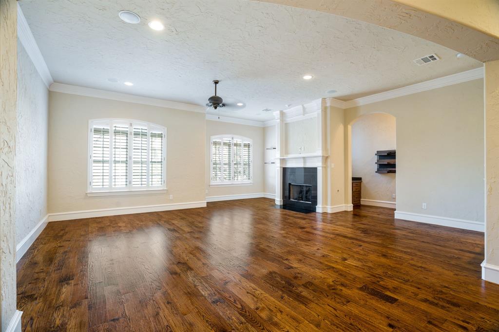 554 Rockingham Drive Irving, TX 75063 - Photo 3 of 34 a view of empty room with wooden floor and fireplace