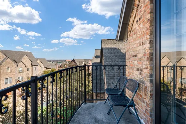 a view of a balcony with furniture