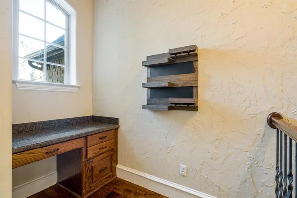 a room with a wooden floor and a window
