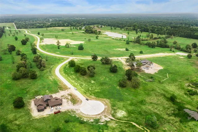 a view of field with grass and a building