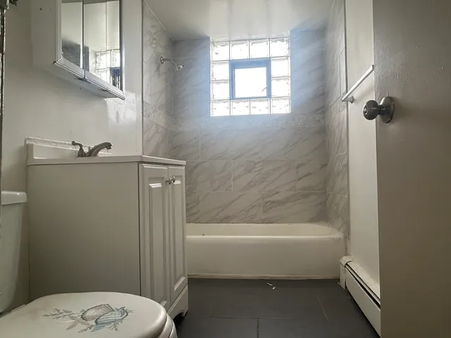 a bathroom with a toilet and a bathtub