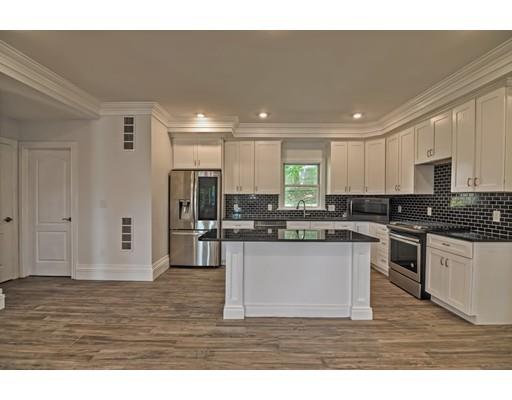 22 East Shore Road Holbrook, MA 02343 - Photo 4 of 27 a kitchen with stainless steel appliances granite countertop a refrigerator a sink dishwasher a stove and white cabinets with wooden floor