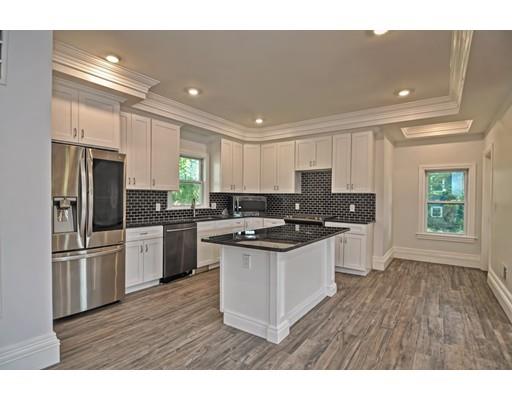 22 East Shore Road Holbrook, MA 02343 - Photo 5 of 27 a kitchen with stainless steel appliances granite countertop a refrigerator a sink dishwasher a stove and white countertops with wooden floor