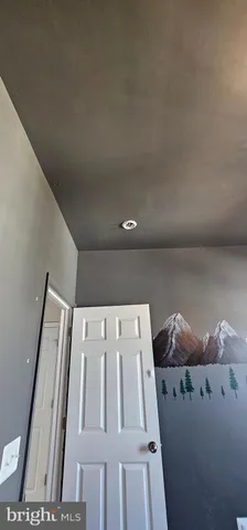 a bedroom with double bunk beds cabinets and a window