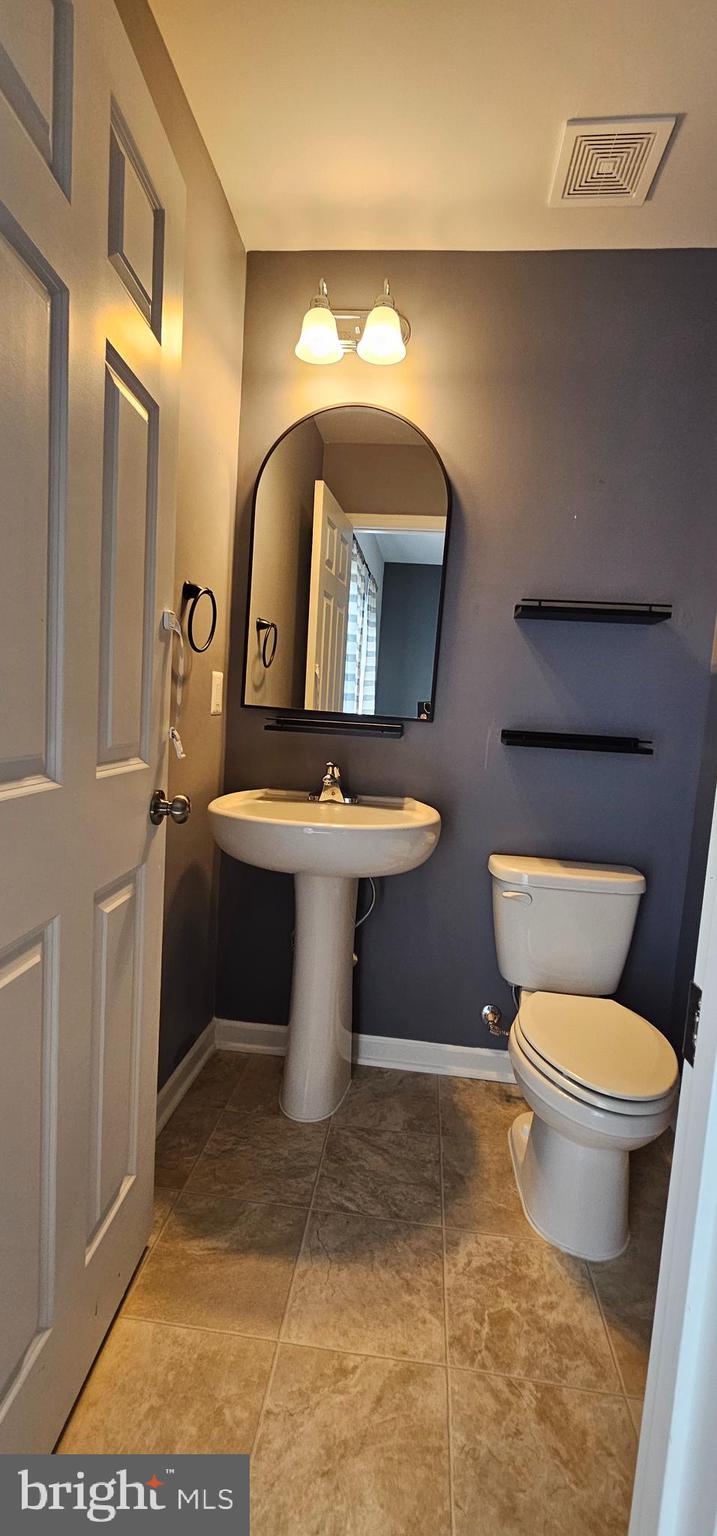 126 Lindy Way Stephenson, VA 22656 - Photo 19 of 22 a bathroom with a toilet sink and mirror