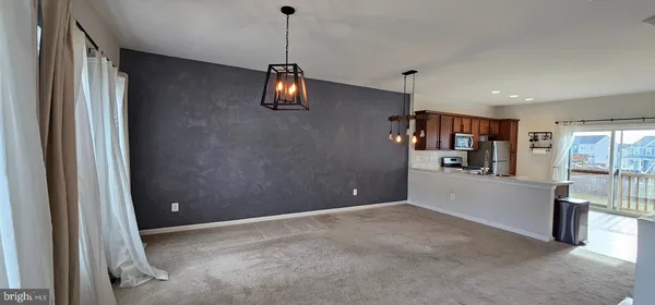 a kitchen with kitchen island a sink appliances and cabinets