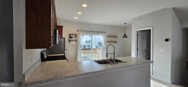a kitchen with stainless steel appliances granite countertop a refrigerator and a stove