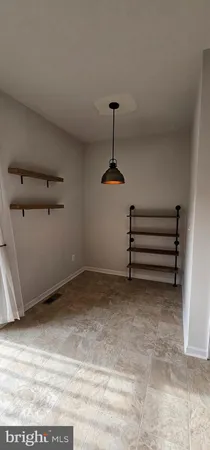 a bathroom with a granite countertop toilet sink and mirror