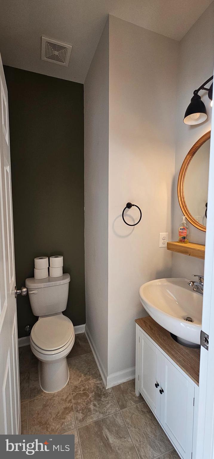 126 Lindy Way Stephenson, VA 22656 - Photo 6 of 22 a bathroom with a granite countertop toilet and a sink