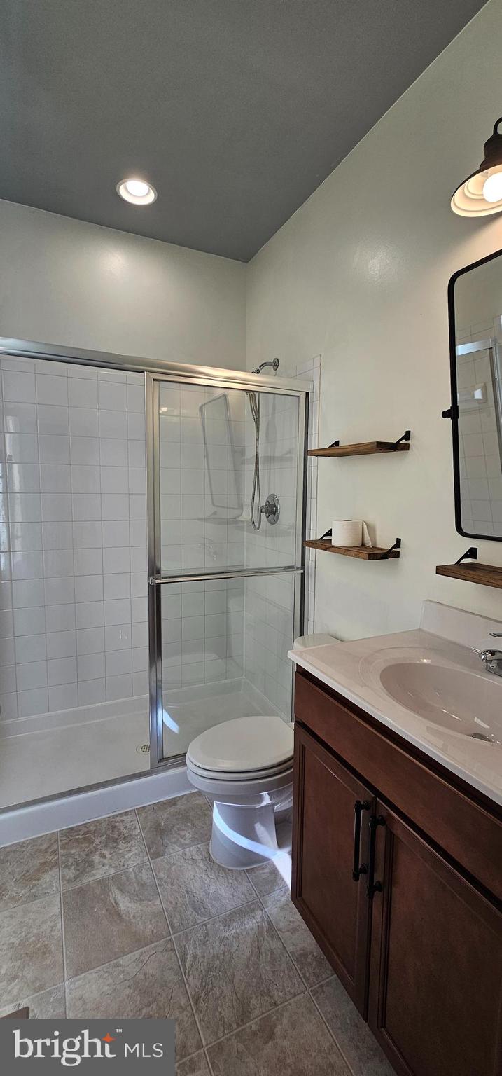 126 Lindy Way Stephenson, VA 22656 - Photo 8 of 22 a bathroom with a granite countertop sink a toilet and shower
