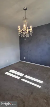 a view of a chandelier in big room and chandelier