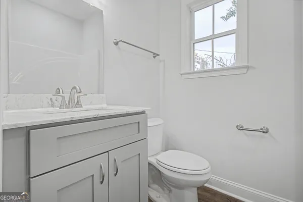 a bathroom with a sink toilet and vanity
