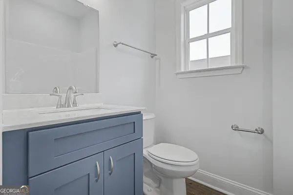 a bathroom with a sink a toilet and window