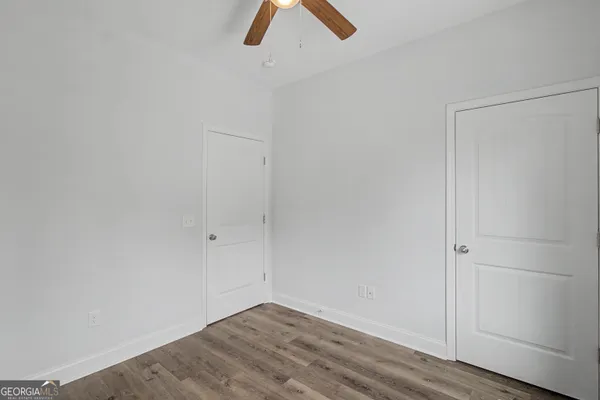 a view of an empty room with wooden floor