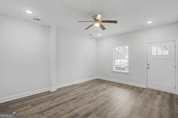 wooden floor in an empty room with a window