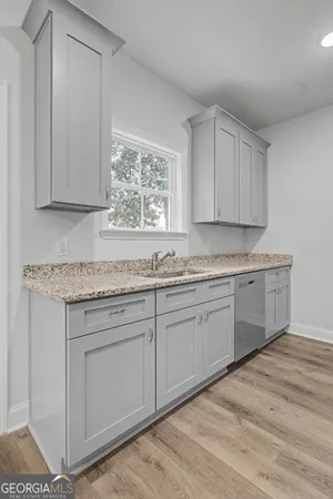 a kitchen with granite countertop cabinets sink and window
