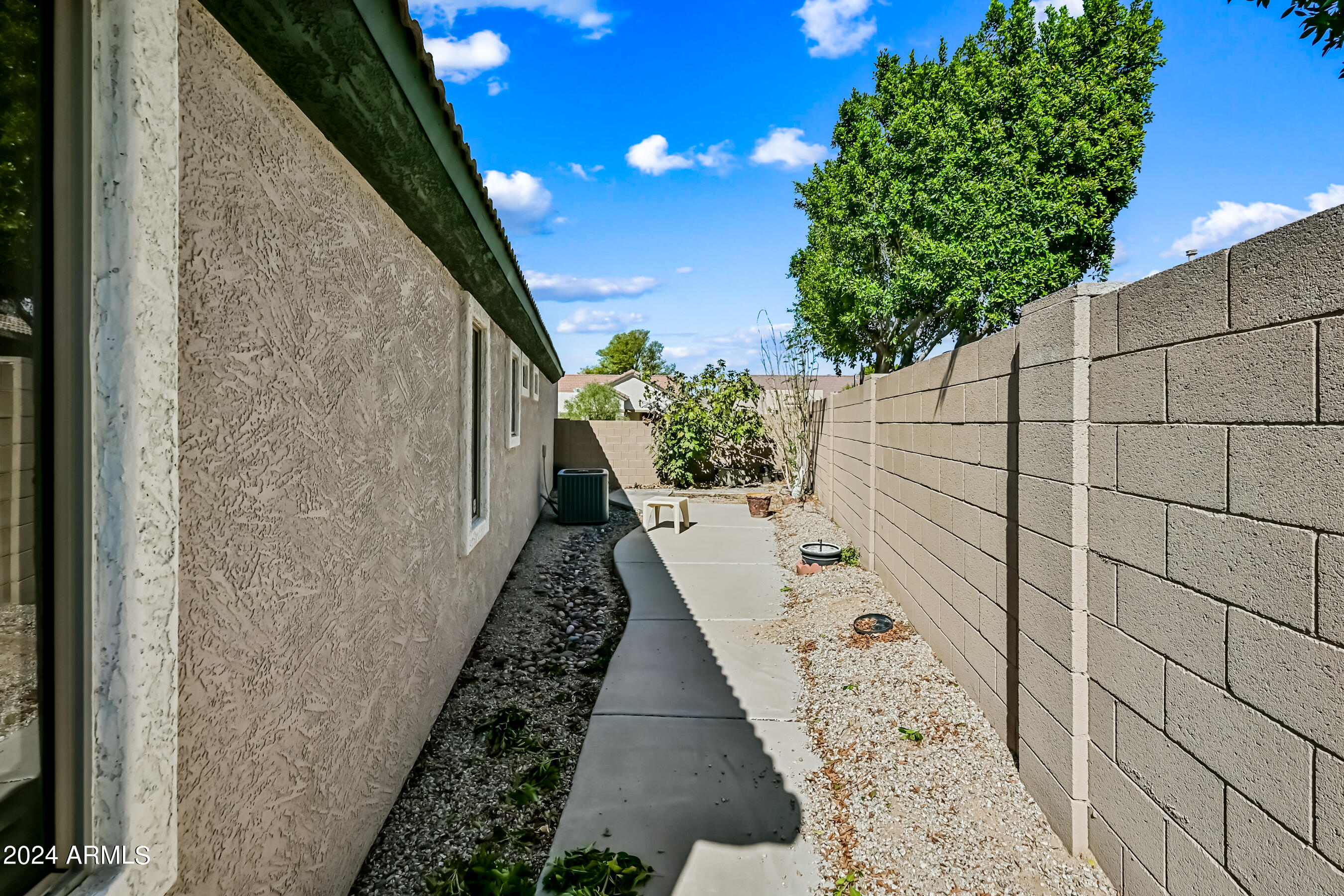 6707 East Roland Street Mesa, AZ 85215 - Photo 15 of 32 a view of a pathway both side of house