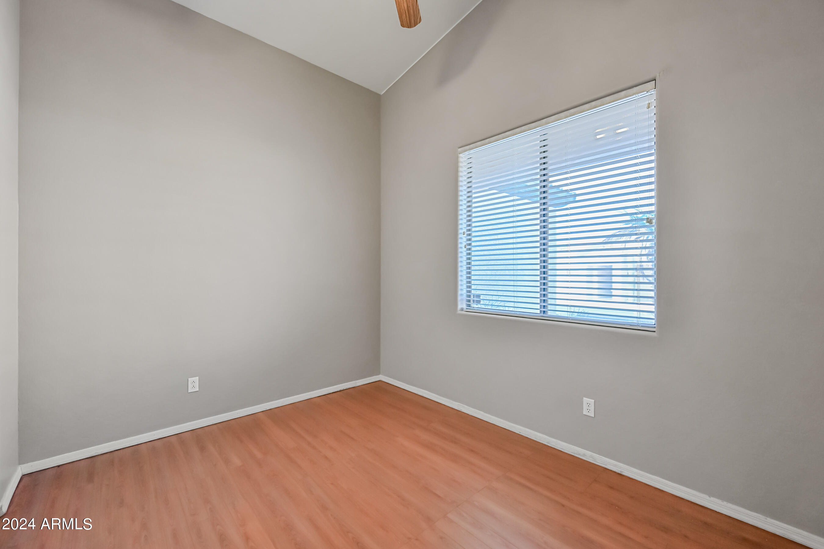 6707 East Roland Street Mesa, AZ 85215 - Photo 26 of 32 an empty room with a window