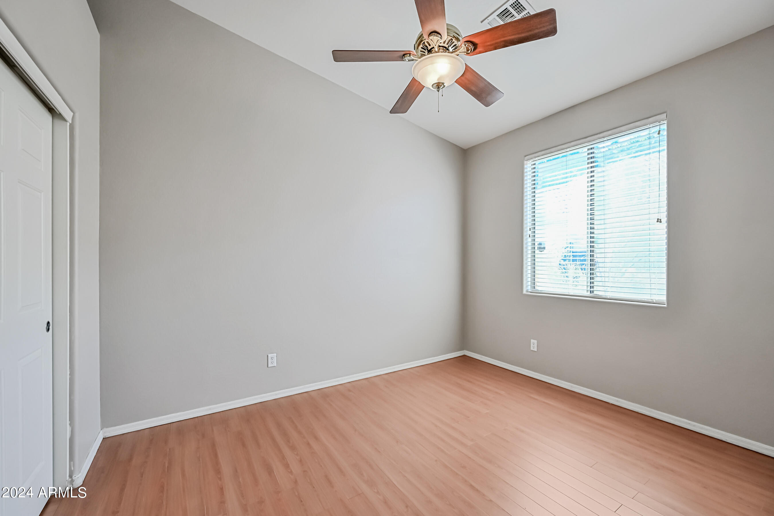 6707 East Roland Street Mesa, AZ 85215 - Photo 28 of 32 an empty room with a window and a fan