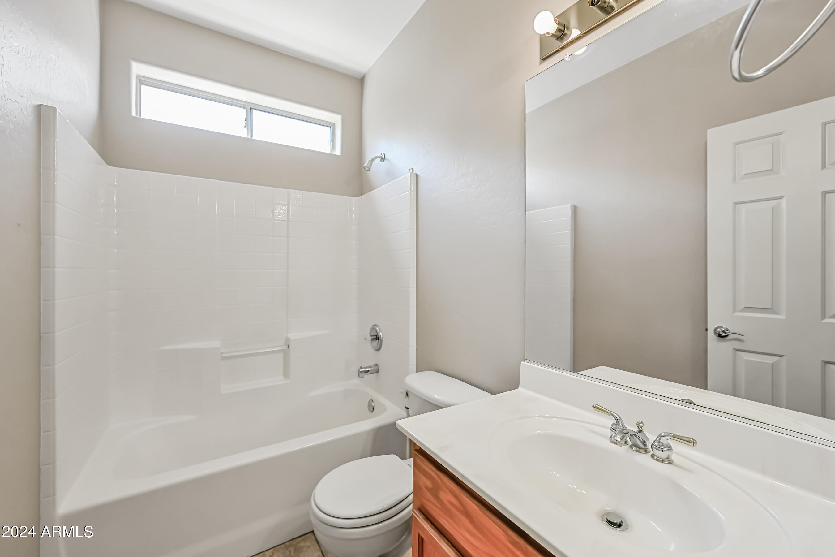 6707 East Roland Street Mesa, AZ 85215 - Photo 29 of 32 a bathroom with a sink a toilet and shower