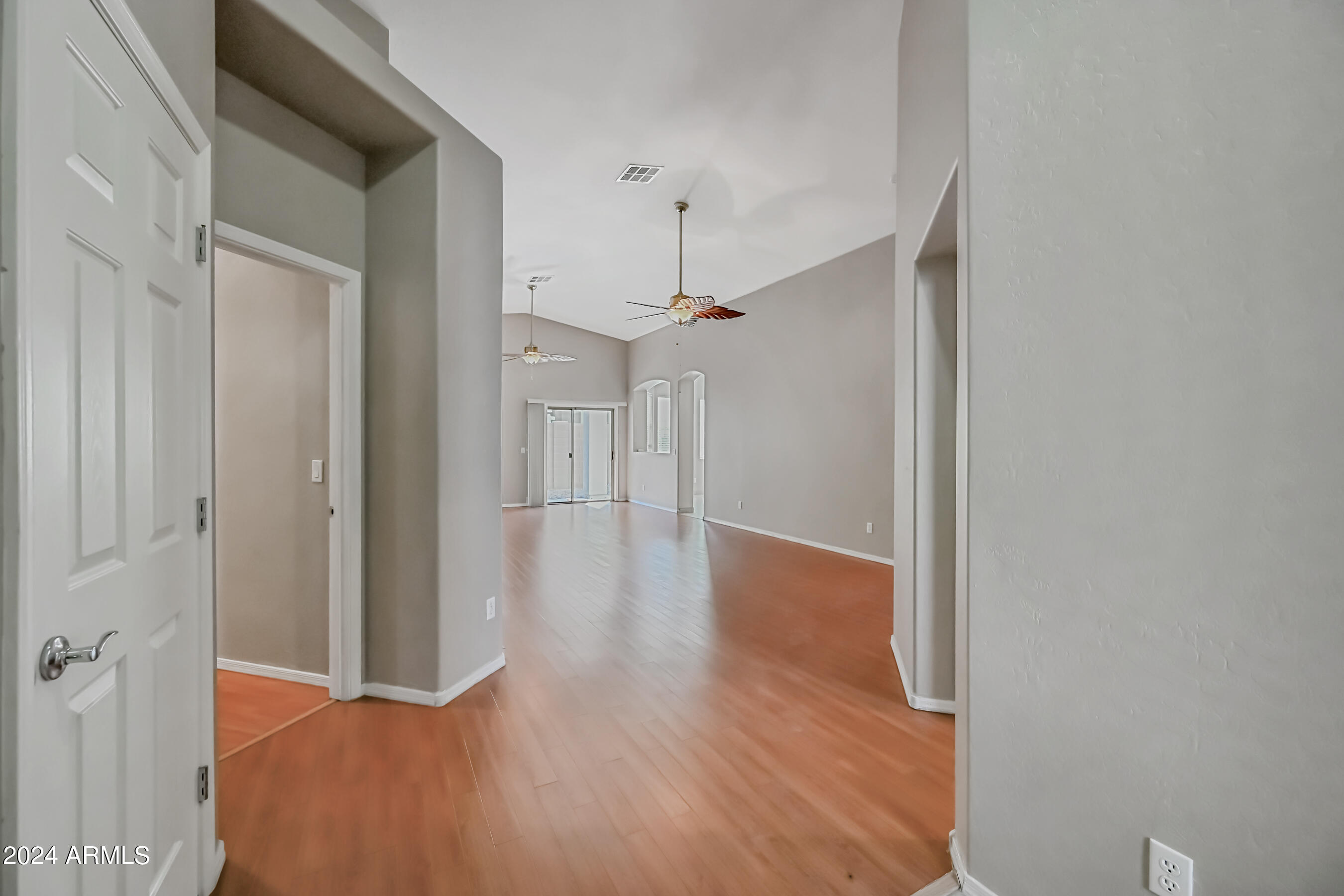 6707 East Roland Street Mesa, AZ 85215 - Photo 4 of 32 a view of a hallway with wooden floor