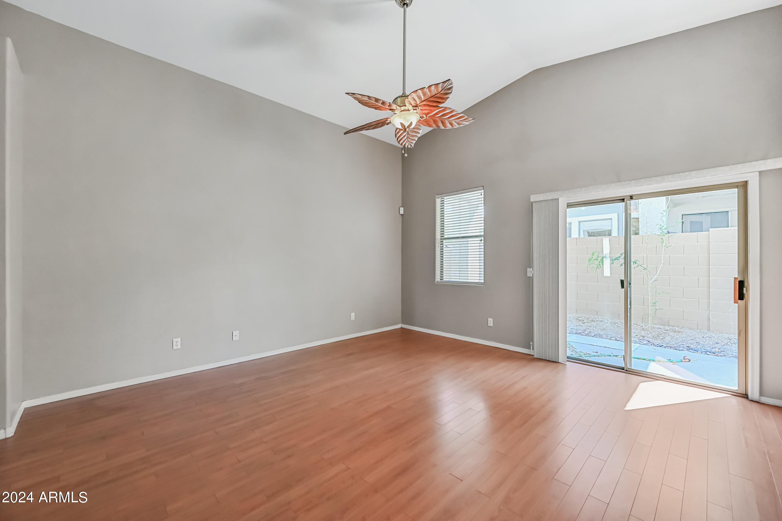 6707 East Roland Street Mesa, AZ 85215 - Photo 7 of 32 a view of a room with a ceiling fan and a window
