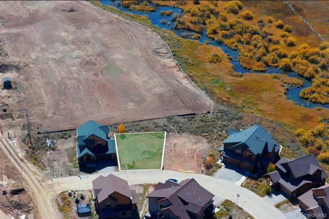 an aerial view of a house with a yard