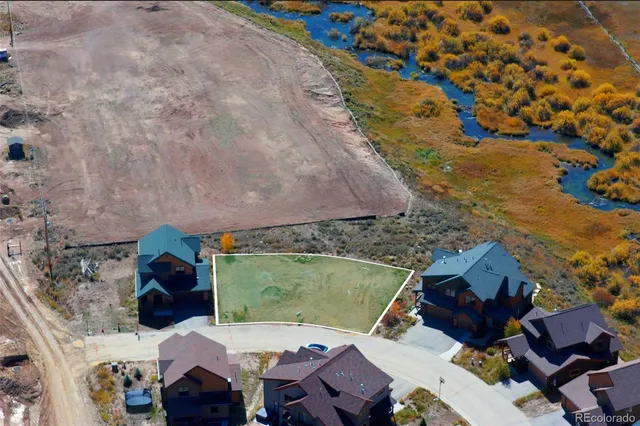 an aerial view of a house with a yard