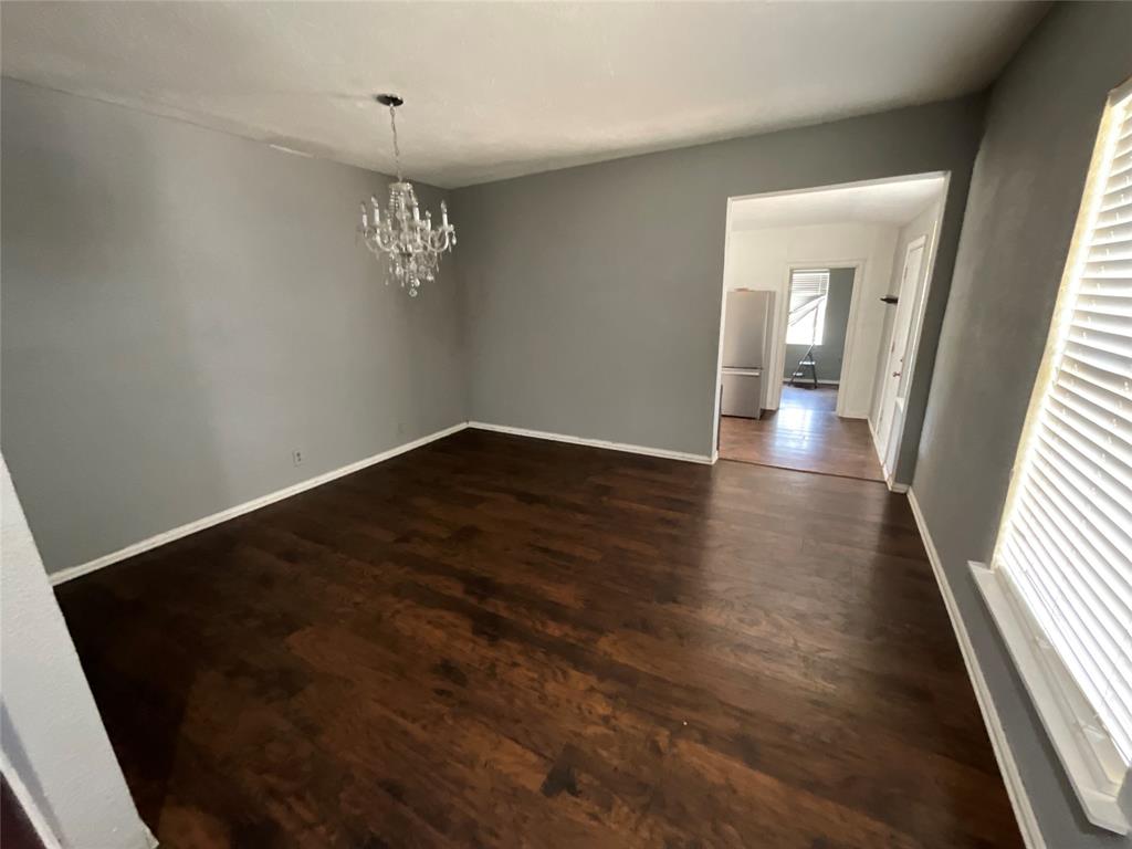 629 Harrison Lane Hurst, TX 76053 - Photo 6 of 20 wooden floor in an empty room with a window