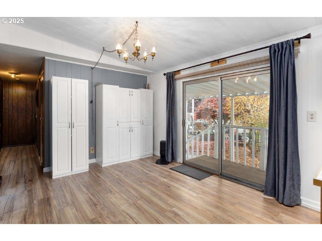 406 Shadow Ranch Lane Roseburg, OR 97470 - Photo 15 of 32 a view of an empty room with wooden floor and a window