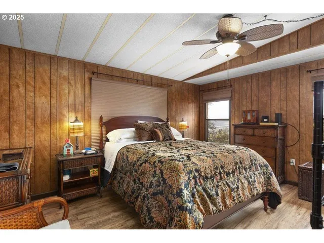 a bedroom with a bed and a large mirror with a flat tv screen