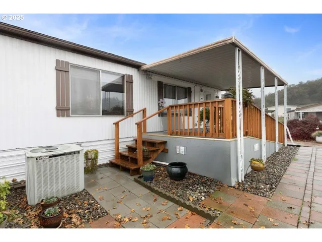 a white house with a yard and garden