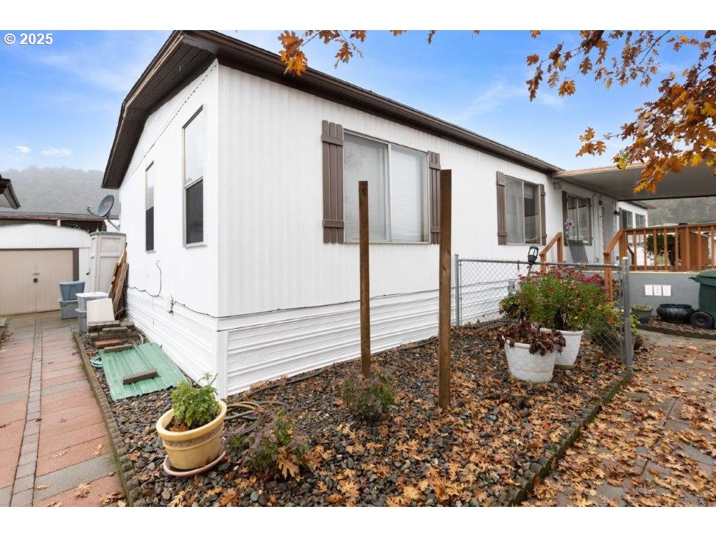 406 Shadow Ranch Lane Roseburg, OR 97470 - Photo 29 of 32 a white house with a yard and garden