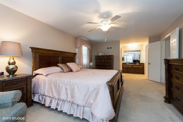 3561 Ronald Road Crete, IL 60417 - Photo 8 of 18 a spacious bedroom with a bed and a chandelier