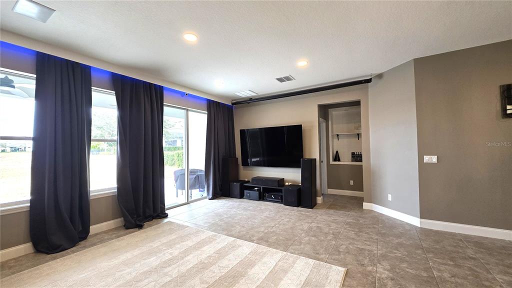 5531 Cypress Hill Road Winter Garden, FL 34787 - Photo 15 of 62 a living room with furniture and a flat screen tv