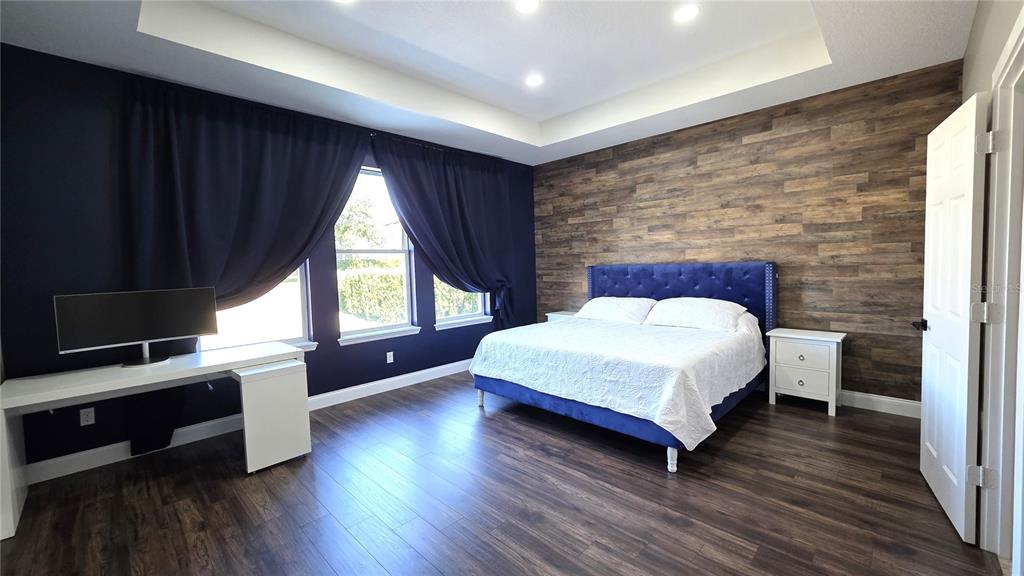 5531 Cypress Hill Road Winter Garden, FL 34787 - Photo 17 of 62 a spacious bedroom with a bed and a large window