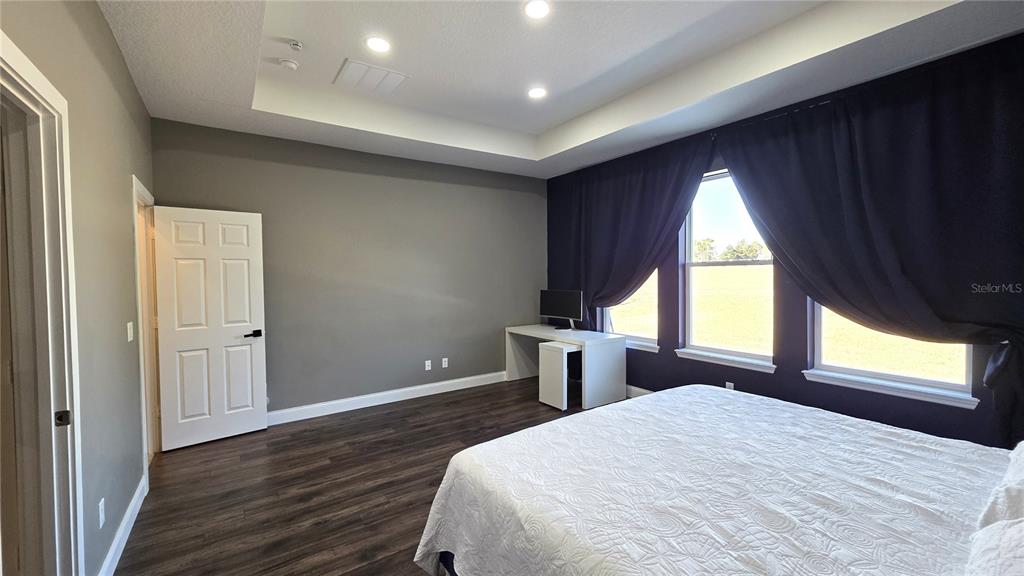 5531 Cypress Hill Road Winter Garden, FL 34787 - Photo 20 of 62 a bedroom with a bed and a large window