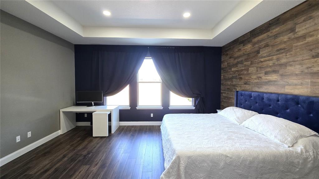 5531 Cypress Hill Road Winter Garden, FL 34787 - Photo 21 of 62 a spacious bedroom with a bed and wooden floor