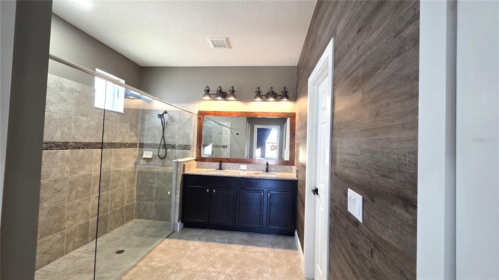 5531 Cypress Hill Road Winter Garden, FL 34787 - Photo 23 of 62 a bathroom with a sink and mirror with shower
