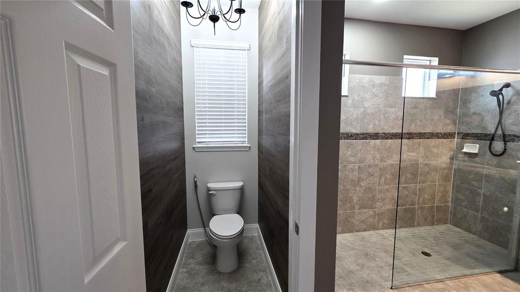 5531 Cypress Hill Road Winter Garden, FL 34787 - Photo 25 of 62 a bathroom with a toilet and a shower