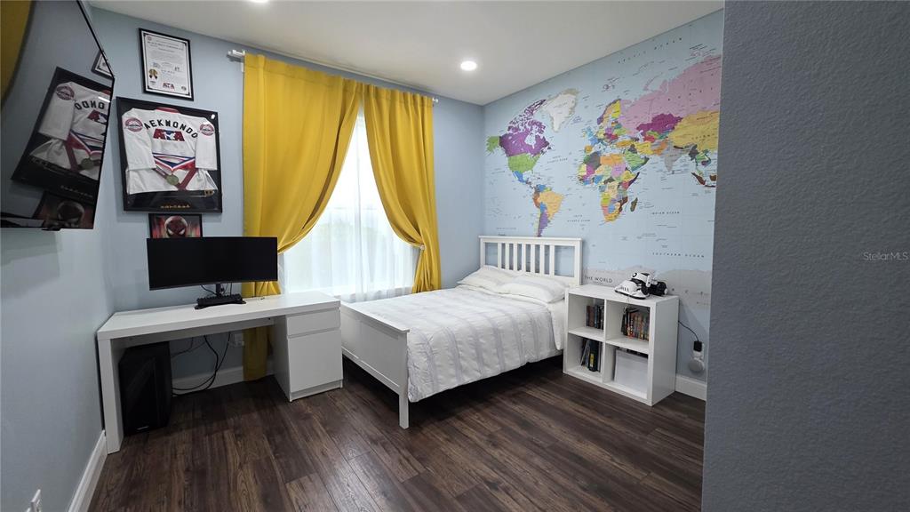 5531 Cypress Hill Road Winter Garden, FL 34787 - Photo 30 of 62 a bedroom with a bed and a bookshelf