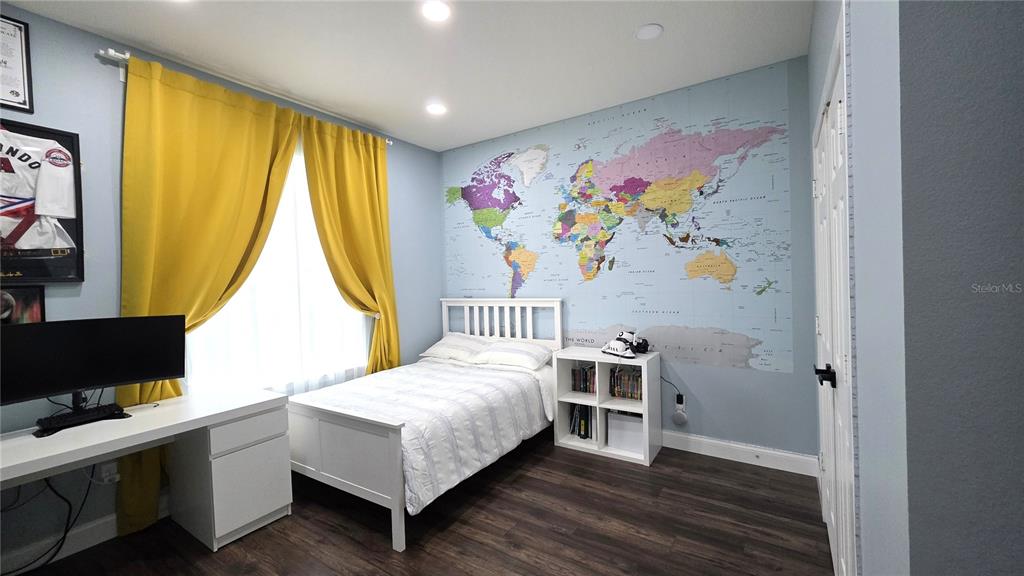 5531 Cypress Hill Road Winter Garden, FL 34787 - Photo 32 of 62 a bedroom with a bed and a flat screen tv