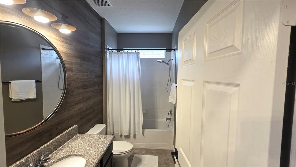 5531 Cypress Hill Road Winter Garden, FL 34787 - Photo 34 of 62 a bathroom with a granite countertop sink toilet and shower