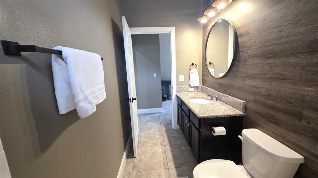 5531 Cypress Hill Road Winter Garden, FL 34787 - Photo 36 of 62 a bathroom with a sink vanity mirror and toilet