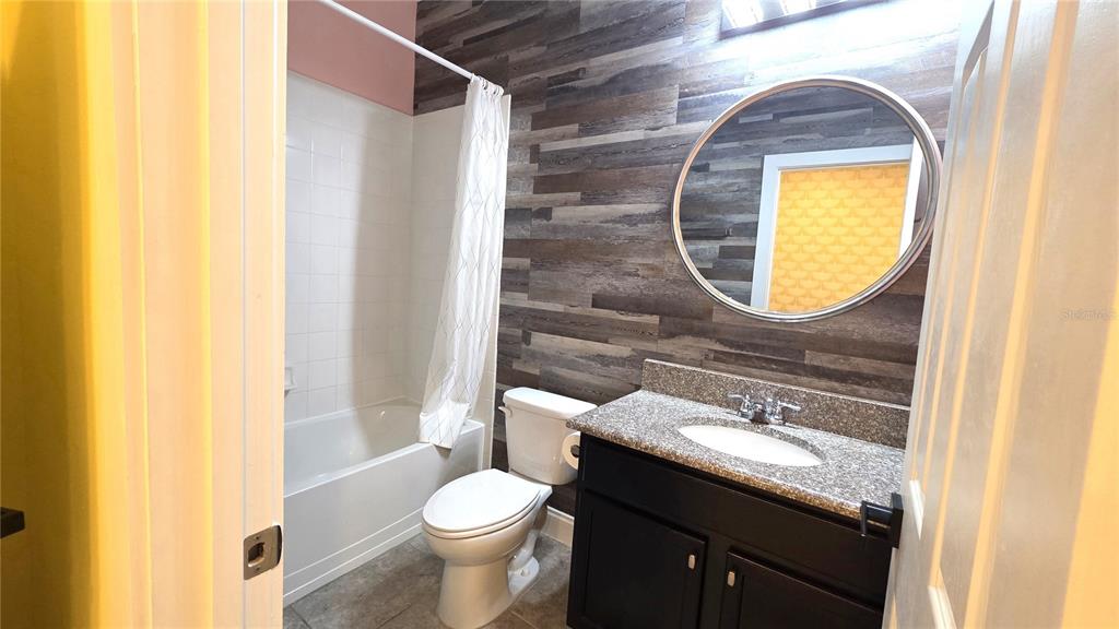 5531 Cypress Hill Road Winter Garden, FL 34787 - Photo 45 of 62 a bathroom with a granite countertop toilet sink and mirror