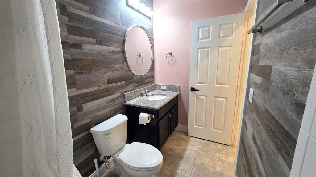 5531 Cypress Hill Road Winter Garden, FL 34787 - Photo 46 of 62 a bathroom with a toilet a sink and a mirror