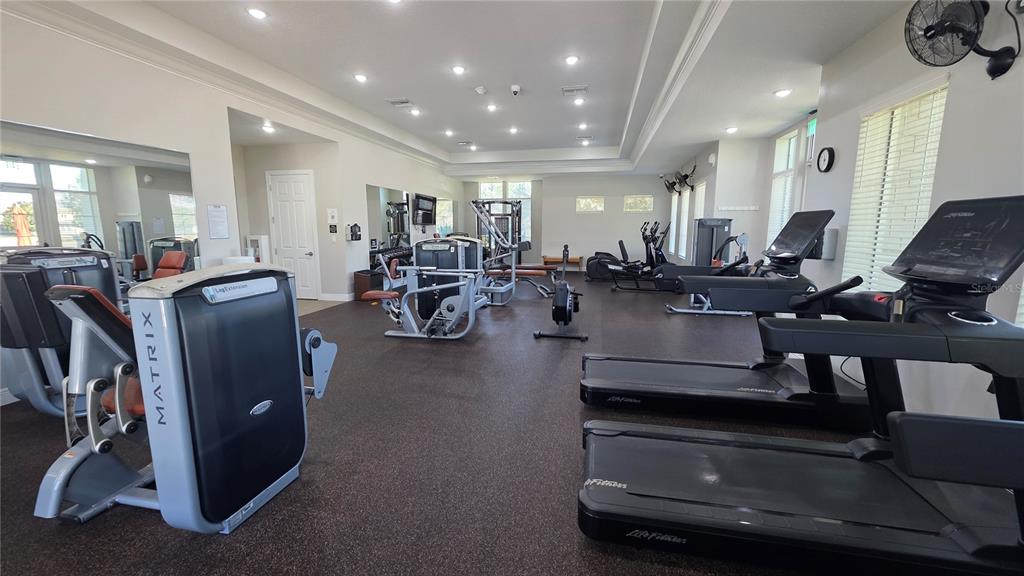 5531 Cypress Hill Road Winter Garden, FL 34787 - Photo 59 of 62 a living room with lots of furniture and gym equipment